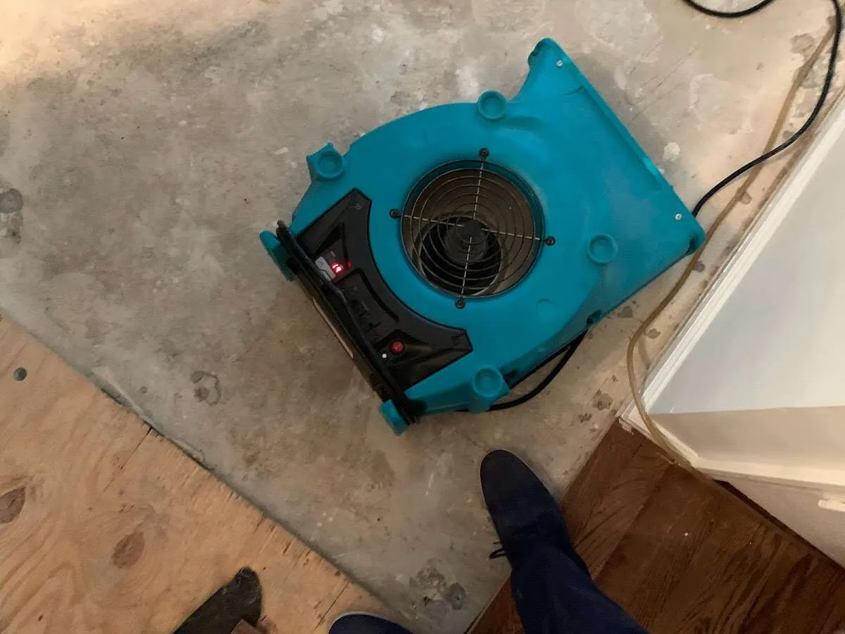 Air mover drying subfloor during Commercial Water Damage Restoration in Bridgeton